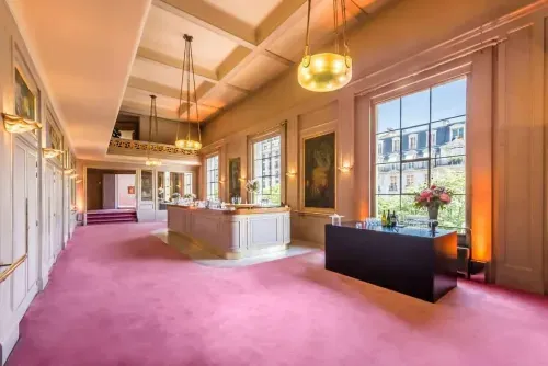 Neoclassical hall with pink carpeting in Paris
