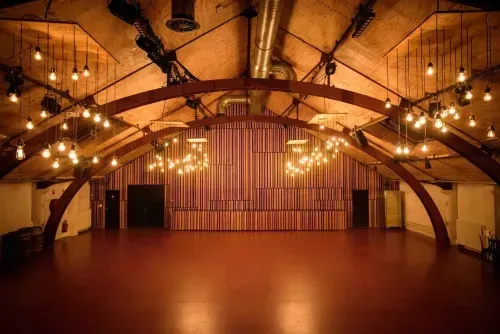 Industrial Venue With Arched Ceiling and Warm Glow for Conferences