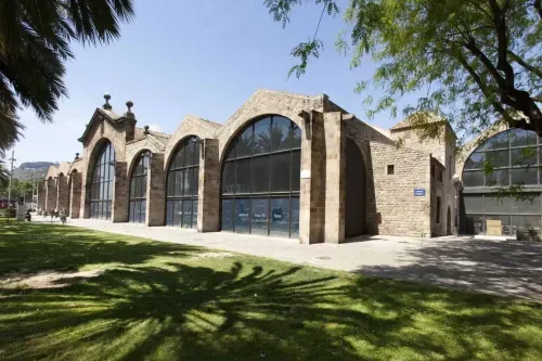 Historic Royal Shipyards building in Barcelona with Gothic arched brick facade and large glass windows, hosts up to 1,000 guests