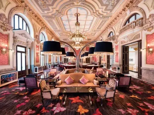 Rococo Belle Époque ballroom in Madrid with an ornate painted ceiling, crystal chandeliers and butterfly-patterned carpet, hosts up to 120 guests