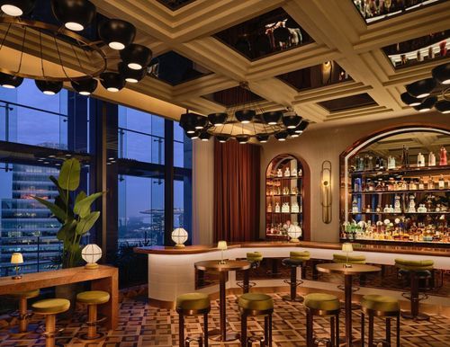 Art Deco Bar With Mirrored Coffered Ceilings and Skyline Views
