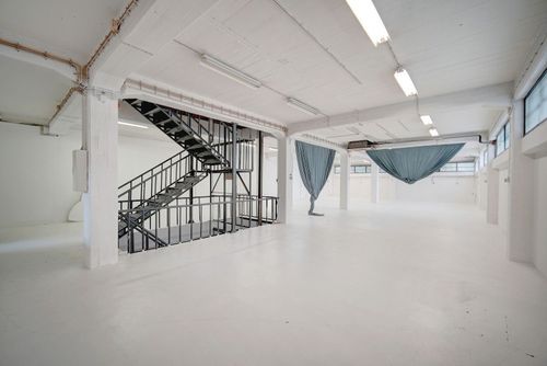 Minimalist White Gallery With Industrial Charm