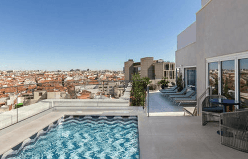 Modern rooftop terrace in Madrid with plunge pool, sun loungers and city skyline views, set up for elegant events on Eventflare